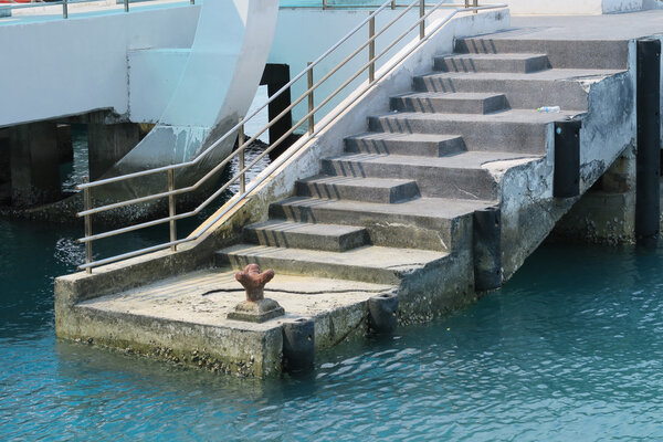 iron mooring a boat to a pier.