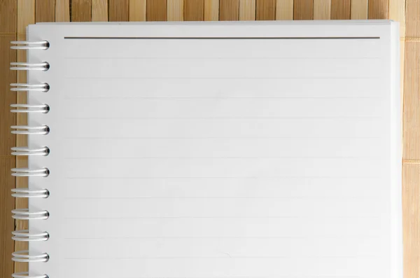 Prázdný Poznámkový blok Poznámkový blok s tužkou na hnědé bambusové pozadí — Stock fotografie