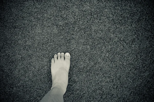 Foot on artificial grass — Stock Photo, Image