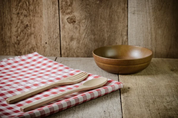 Tovaglia, cucchiaio di legno, forchetta su sfondo con texture in legno — Foto Stock