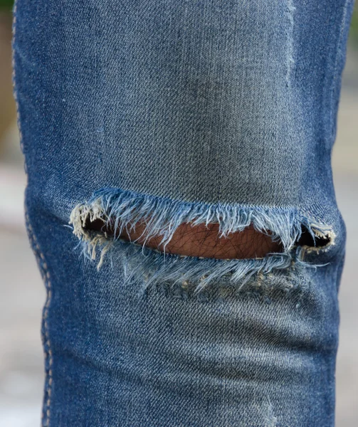Blue faded ripped jeans — Stock Photo, Image