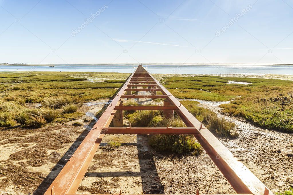 Beautiful landscape with an abandoned pier of Ria Formosa Natural Park, Olhao, Algarve, Portugal