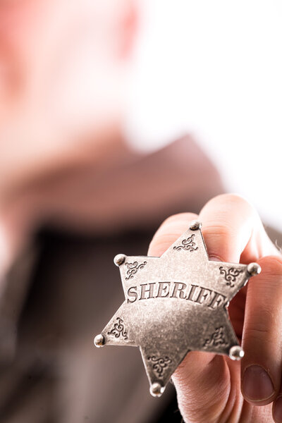 Man holds sheriff badge