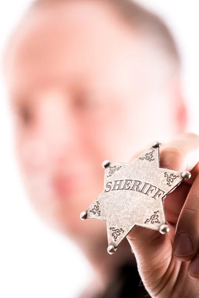 Man holds sheriff badge — Stock Photo, Image