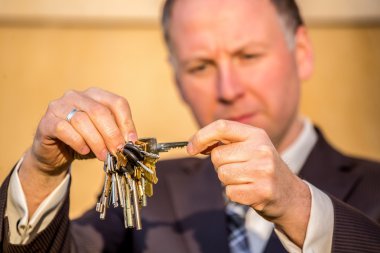 Businessman choosing the right key clipart