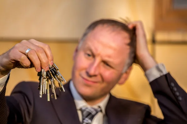 Businessman choosing the right key — Stock Photo, Image