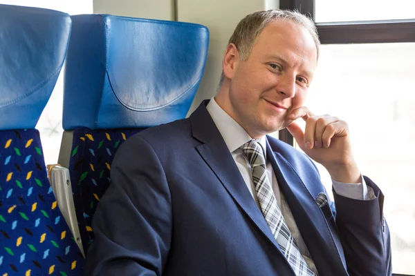 Businessman sitting in a train — Stock Photo, Image