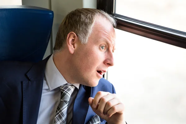 Businessman surprised what he sees through window — Stock Photo, Image