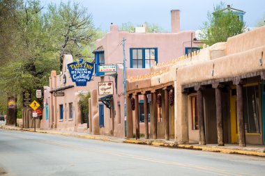 Buildings in Taos, which is the last stop before entering Taos P clipart