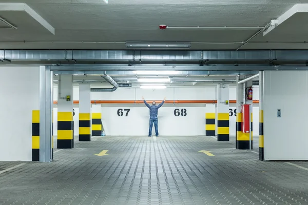 Uomo in piedi al parcheggio vuoto — Foto Stock