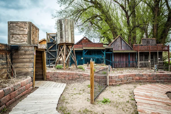 Small old town with wooden buildings and entrance to a mine — Stock Photo, Image