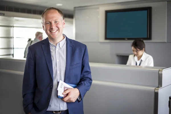 Businessman with passport and boarding pass at the airport