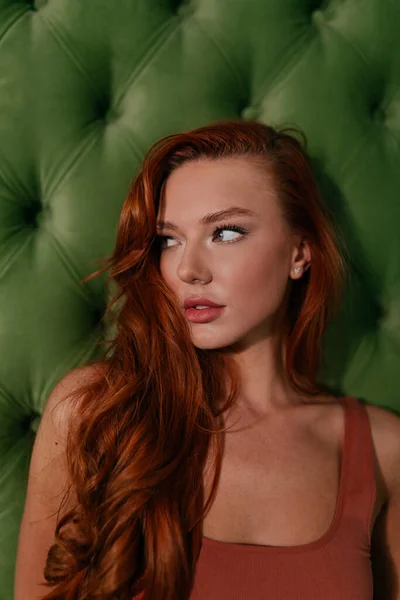 漂亮的红头发女人在绿色的背景上摆出一副可爱的样子 高质量的照片 — 图库照片