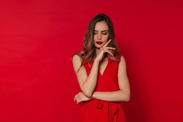 Donna europea in abito rosso con rossetto rosso occhi chiusi e su sfondo rosso, San Valentino, vacanza, compleanno — Foto Stock