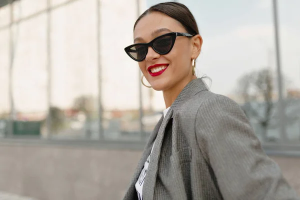Gadis tertawa menggemaskan berpose di atas bangunan modern di kota. Foto wanita Kaukasia ceria dengan senyum yang indah. — Stok Foto