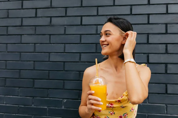 Close up portrait of charming smiling girl with short hair and wearing summer dress looking aside and smiling over isolated background — 스톡 사진