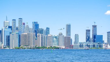 Toronto ON, Kanada - 3 Temmuz 2022: Toronto ufuk çizgisine limandan bakmak, modern binaları ve açık gökyüzünü vurgulamak, kentsel yaşam tarzı temaları için mükemmel