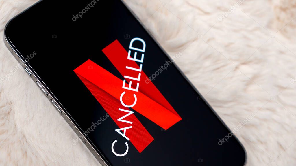 Ottawa ON, Canada - October 06, 2025: Mobile device shows Netflix logo with 'CANCELLED' text on screen, placed on a plush background, conveying subscription termination