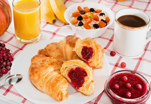 Petit déjeuner avec café, croissants, jus et fruits . — Photo