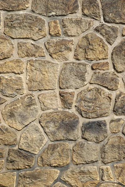 Вертикальный Крупный План Древней Каменной Стены Плотно Прилегающими Абстрактными Формами — стоковое фото