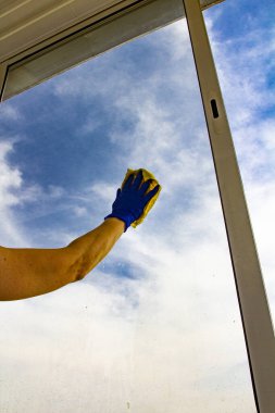 Süngerli kadın eli sabun köpüğüyle pencereyi temizler. Cam yıkama, bahar konsepti..