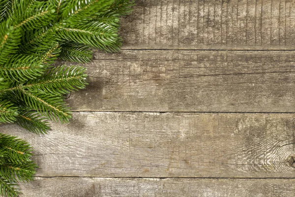 Branches of a Christmas tree as a frame on a rustic background. Top view, flat lay, place for text, copy space.