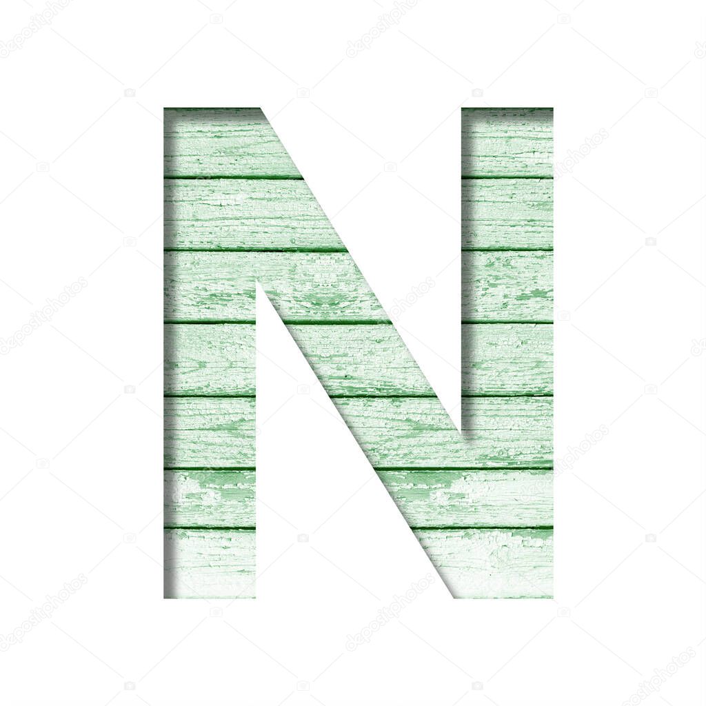 Font on an old wooden wall. The letter N cut out of paper on the background old wood wall with peeled green paint. Set of decorative fonts.