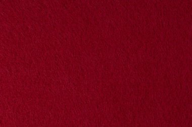 Yakın plan keçe dokusu arka plan olarak, koyu kırmızı renk.
