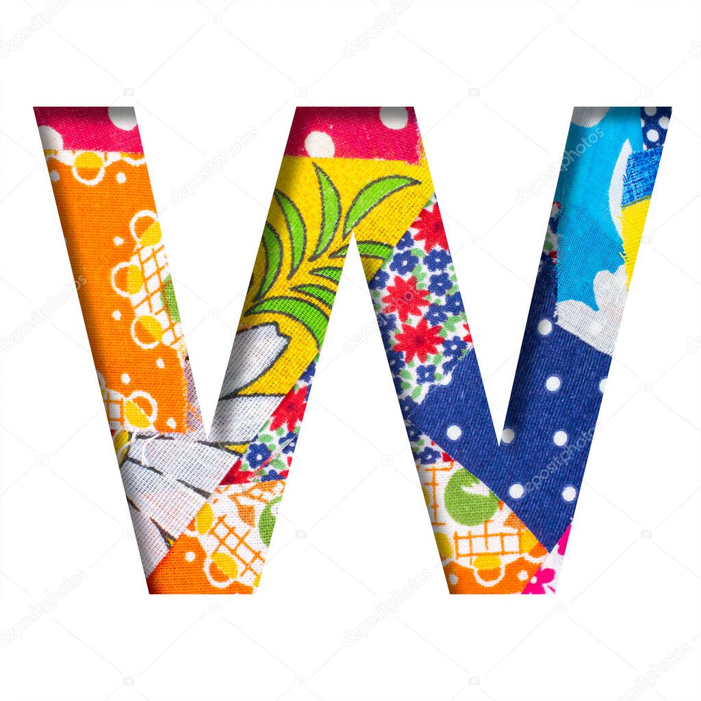 Handicraft or creative font. The letter W cut out of paper on the background of the texture of pieces of colored fabrics for home creativity or needlework. Set of decorative fonts.