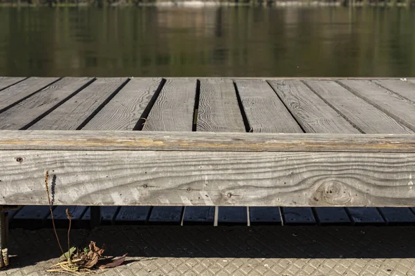 Wooden table on the river bank, close-up.