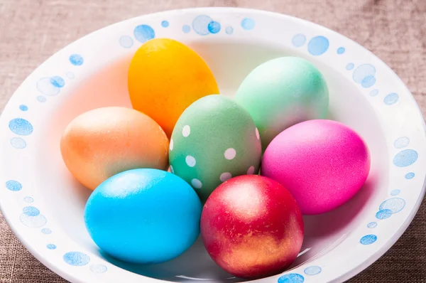 Colorful Easter eggs on white plate — Stock Photo, Image