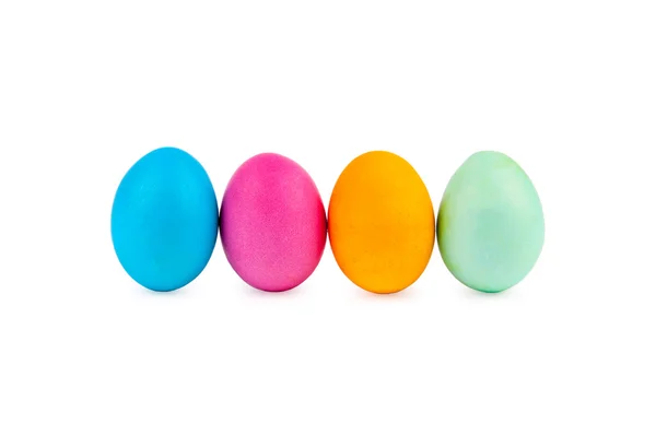 Standing colorful Easter eggs at line with shadows on white background — Stock Photo, Image