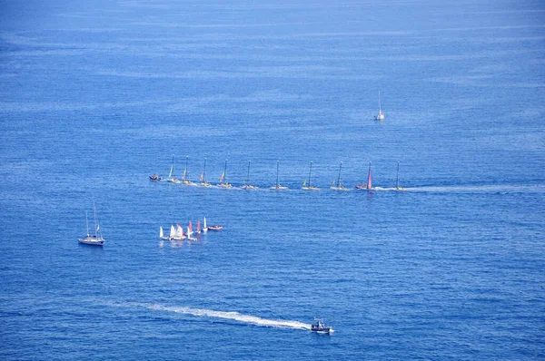 Yachts of a sailing regatta in the sea. Transportation, travel, cruise, sport, recreation, leisure activity, racing, regatta.