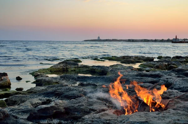 Foc pe malul mării la apusul soarelui — Fotografie, imagine de stoc