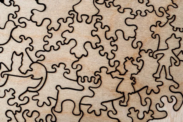 Assembled wooden jigsaw puzzle close up background