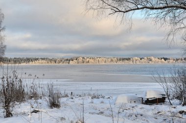 Winter lake covered with snow in winter. Winter landscape