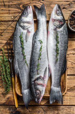 Tepside çiğ deniz kabuğu balığı. Ahşap arka plan. Üst görünüm.