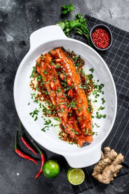 Somon filetosu teriyaki pişiriyorum. Siyah arka plan. Üst görünüm.