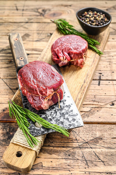 Raw beef meat steak Tenderloin fillet. Wooden background. Top view.