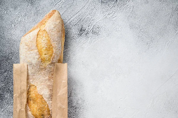 Verse Stokbrood Een Papieren Ambachtelijke Tas Grijze Achtergrond Bovenaanzicht Kopieerruimte — Stockfoto