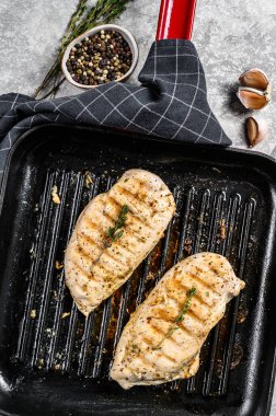 Tavada ızgara tavuk göğsü kekik ve sarımsaklı. gri arka plan. Üst görünüm.