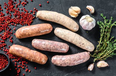 Baharatlı taze çiğ sosis. Siyah arka plan. Üst görünüm.