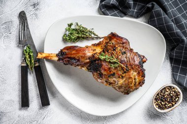 Pişmiş keçi budu ve şifalı otlar. Çiftlik eti. Gri arka plan. Üst görünüm.