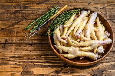 Tahta tabakta çiğ tavuk ayağı. Ahşap arka plan. Üst Manzara. Boşluğu kopyala.