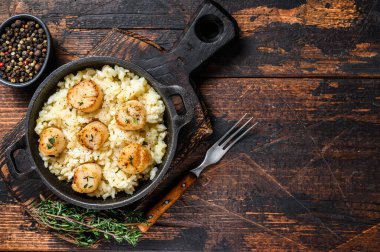 Tavada deniz mahsullü risotto. Koyu ahşap arka plan. Üst Manzara. Boşluğu kopyala.