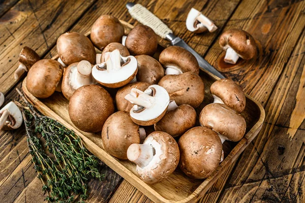 Couper Champignon brun aux champignons crus. fond en bois. Vue du dessus — Photo