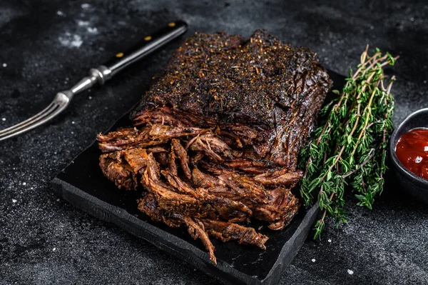 Texas Style BBQ Smoked Beef Brisket meat steak. Black background. Top view