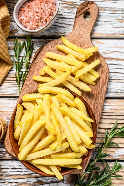 Frozen French fries in a bowl, organic vegetables. White wooden background. Top view — Stock Photo, Image