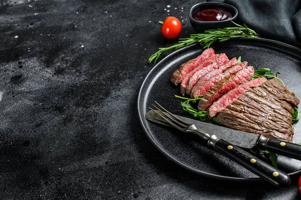 Steak grillé et coupé sur le flanc. Viande de bœuf en marbre. Fond noir. Vue de dessus. Espace de copie — Photo