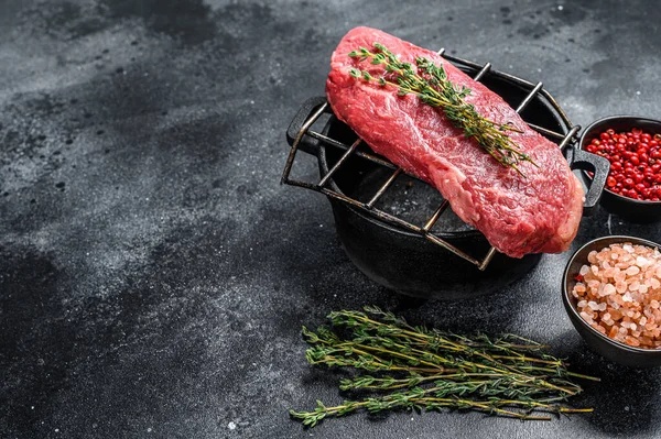 Raw Sirloin steak, beef meat. Dark Wooden background. Top view. Copy space